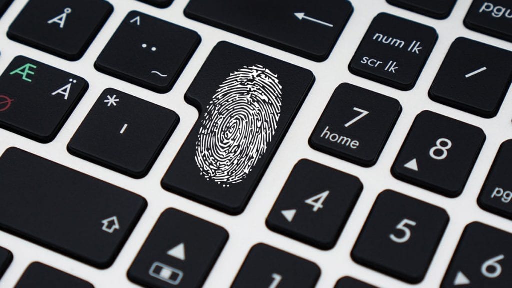 black and white keyboard with thumb print on enter button